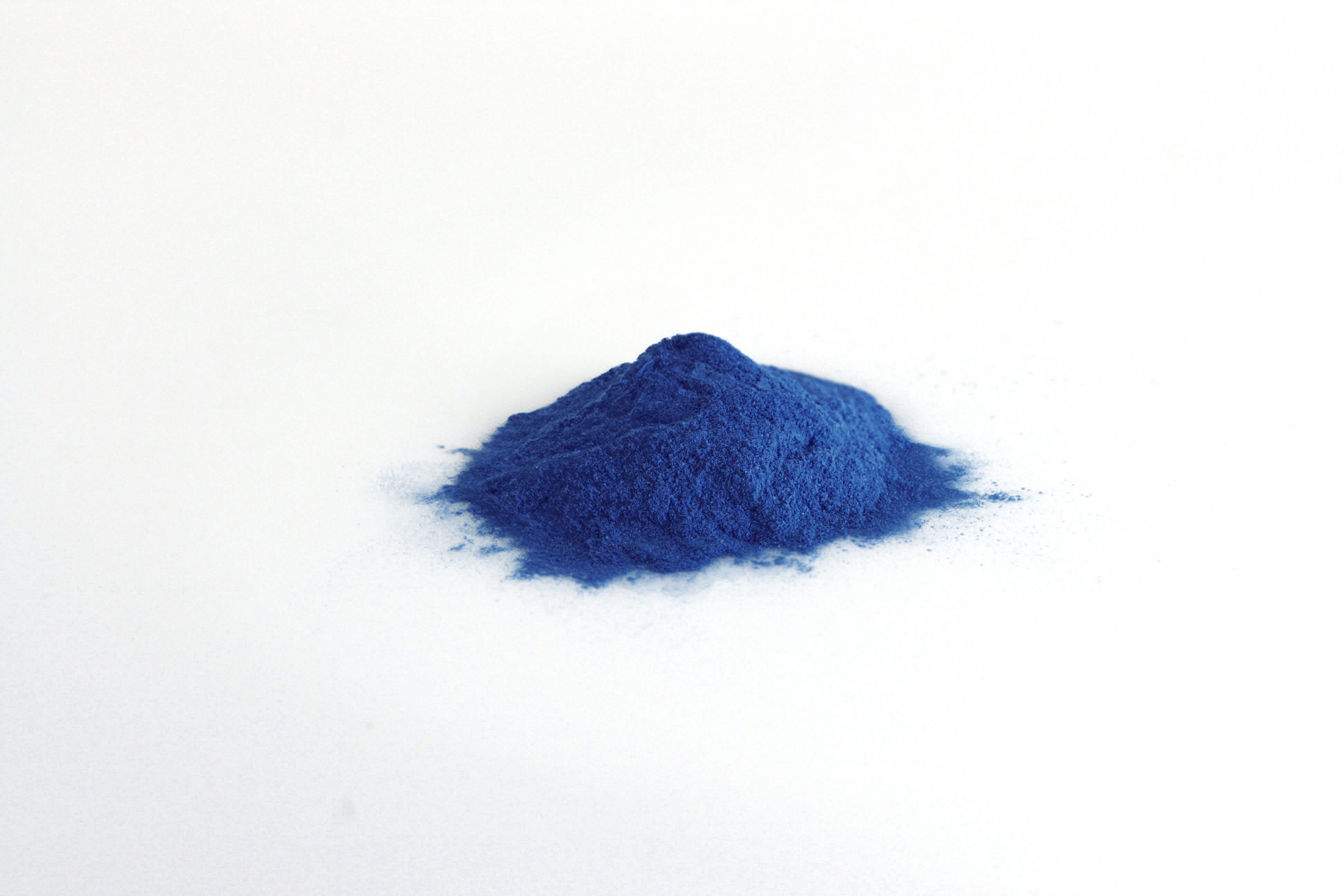 Dark Blue All in one premium-Pile of Dark Blue All in one premium Powder on white background-Excipient-Mix-Granules